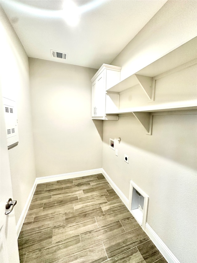 laundry room with cabinets, hookup for an electric dryer, wood-type flooring, and hookup for a washing machine