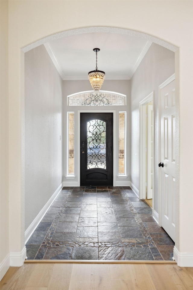 entrance foyer with crown molding and dark wood-type flooring