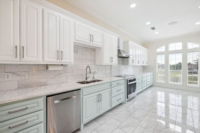 kitchen featuring light stone counters, sink, white cabinets, wall chimney exhaust hood, and stainless steel appliances