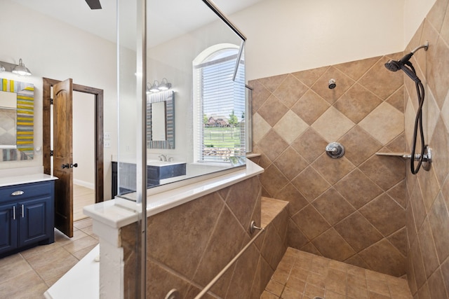 bathroom with vanity, tile patterned flooring, and a tile shower