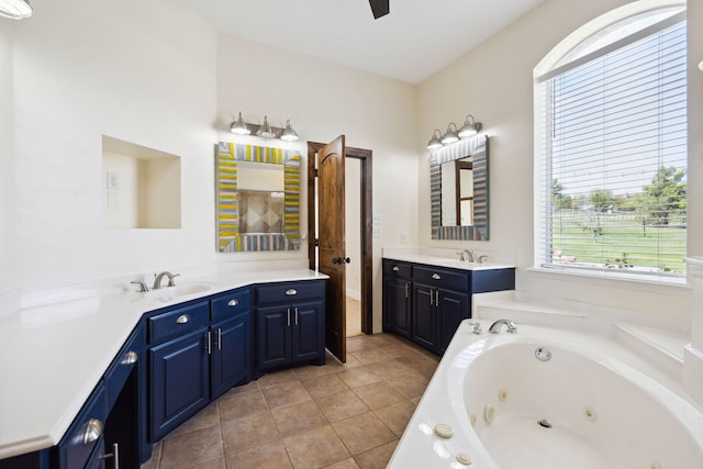 bathroom featuring a tub to relax in, tile patterned flooring, and vanity