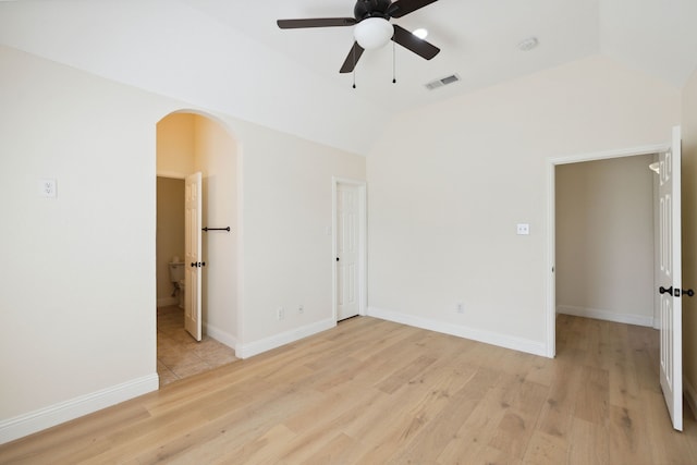 spare room with ceiling fan, light hardwood / wood-style flooring, and vaulted ceiling