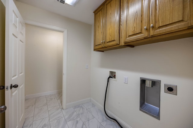 washroom with hookup for an electric dryer, washer hookup, and cabinets