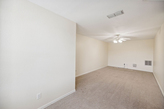 spare room featuring ceiling fan and light colored carpet