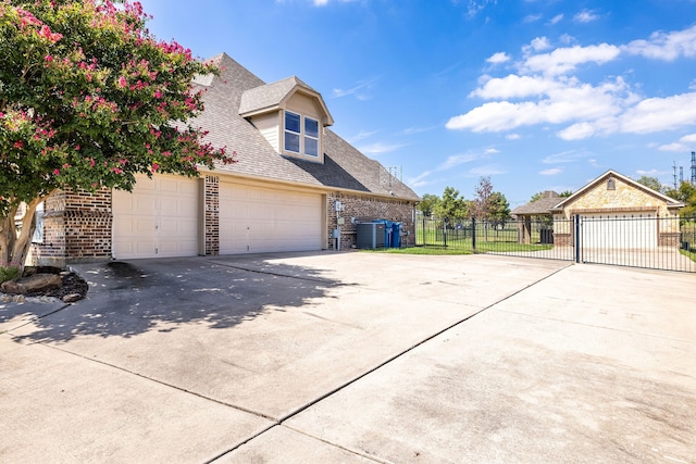 view of property exterior with a garage and central air condition unit