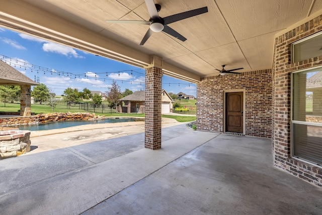 view of patio with ceiling fan and a swimming pool with hot tub