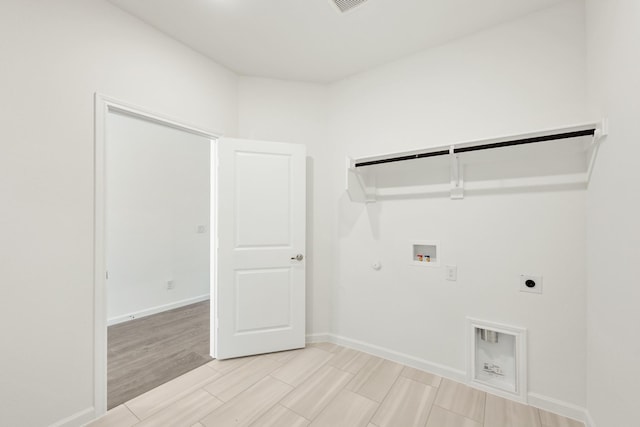 clothes washing area featuring hookup for an electric dryer, washer hookup, and gas dryer hookup