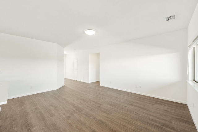 empty room with dark hardwood / wood-style floors