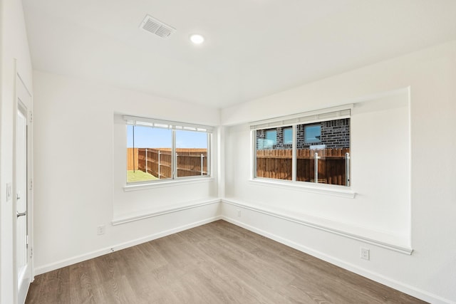 empty room with hardwood / wood-style flooring