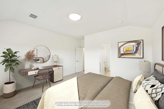 bedroom with connected bathroom, carpet floors, and vaulted ceiling