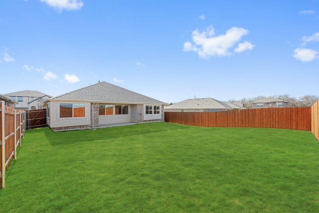 rear view of house featuring a yard