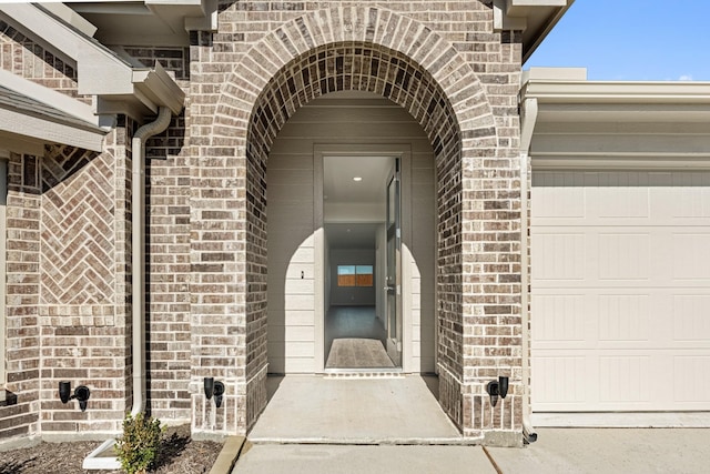 doorway to property with a garage