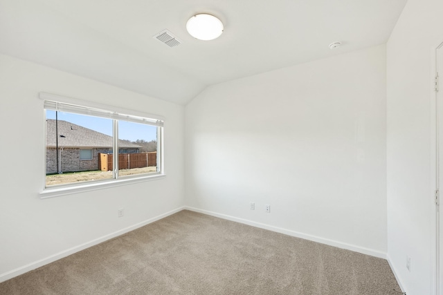 carpeted empty room with lofted ceiling