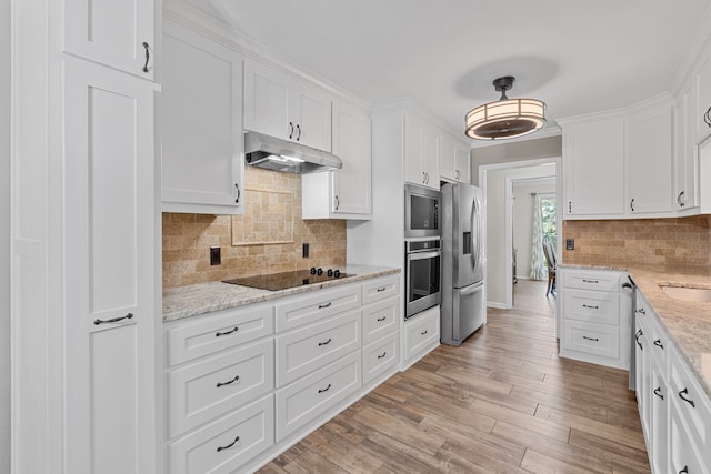 kitchen featuring light stone counters, stainless steel appliances, light wood-type flooring, and white cabinetry