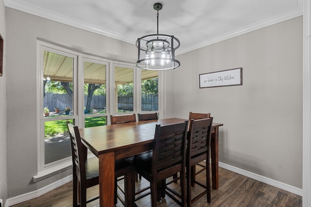 dining space featuring an inviting chandelier, dark wood-type flooring, a healthy amount of sunlight, and crown molding