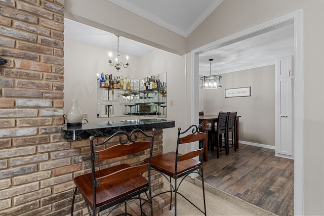 bar featuring ornamental molding, hardwood / wood-style floors, a chandelier, and pendant lighting