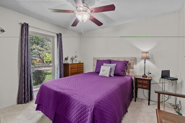 bedroom featuring ceiling fan, a textured ceiling, lofted ceiling, and light carpet