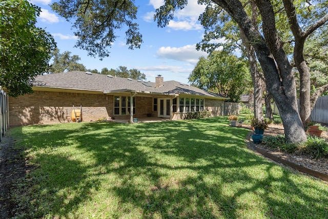 back of property featuring a lawn and a patio area