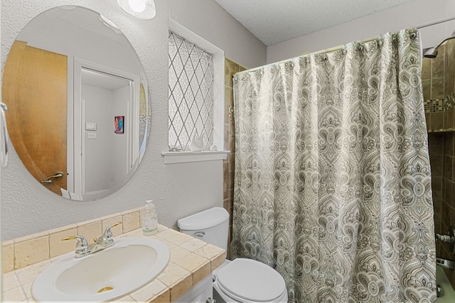 bathroom featuring vanity, a textured ceiling, toilet, and a shower with shower curtain