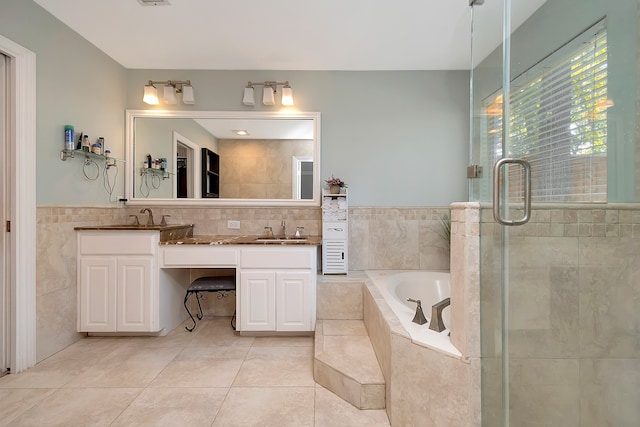 bathroom featuring vanity, plus walk in shower, tile patterned flooring, and tile walls