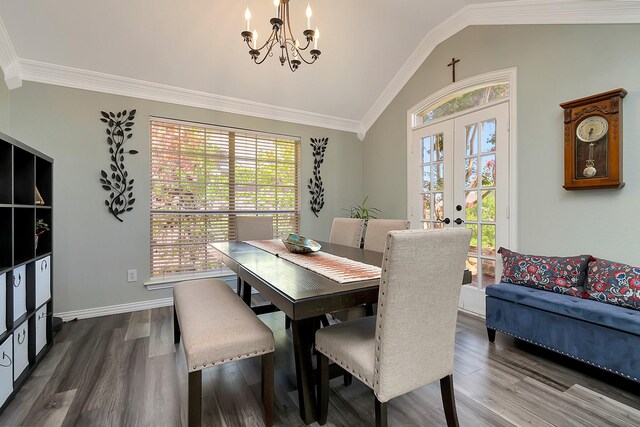 dining space with ornamental molding, french doors, high vaulted ceiling, dark hardwood / wood-style floors, and a notable chandelier