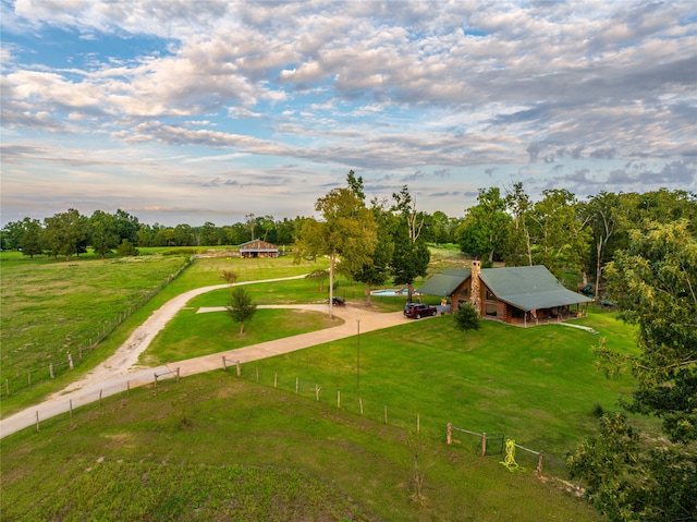 view of property's community with a yard and a rural view