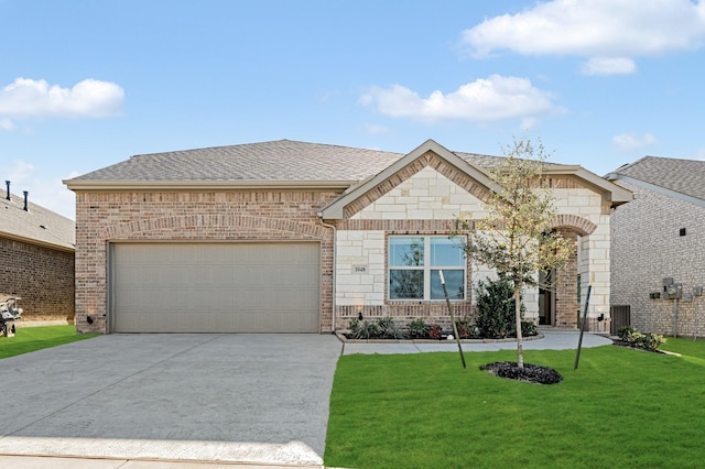 view of front of house with a front yard and a garage