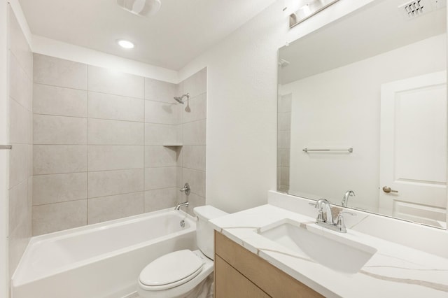 full bathroom with vanity, toilet, and tiled shower / bath