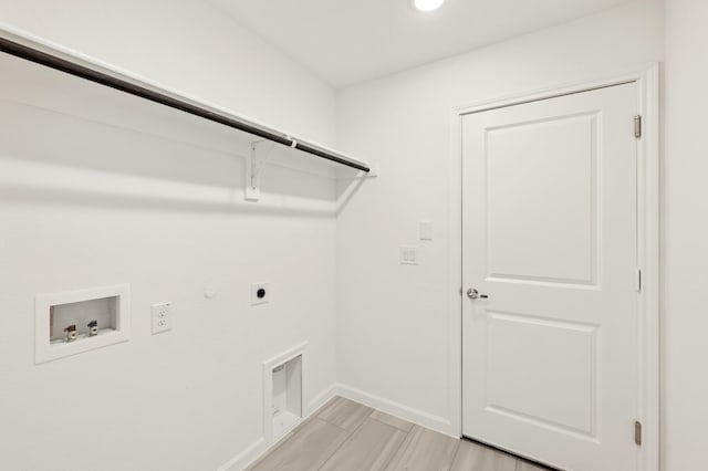 laundry area featuring electric dryer hookup, light hardwood / wood-style floors, hookup for a gas dryer, and hookup for a washing machine