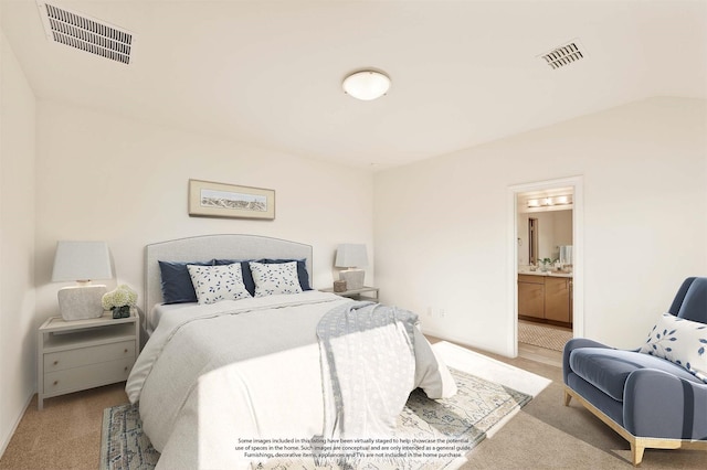 carpeted bedroom featuring ensuite bathroom