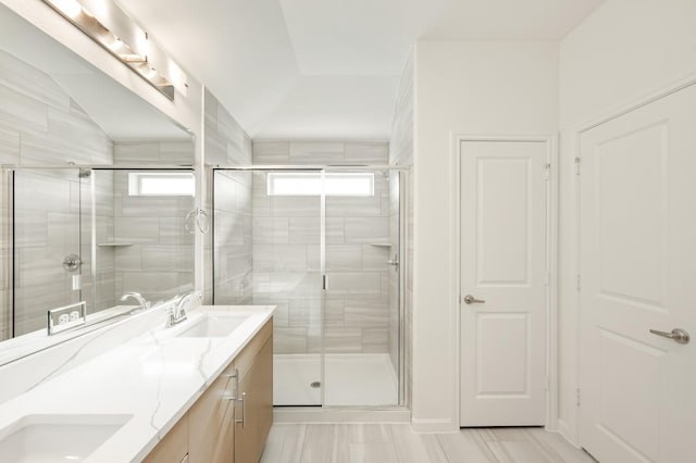 bathroom with a shower with door, vanity, hardwood / wood-style floors, and lofted ceiling