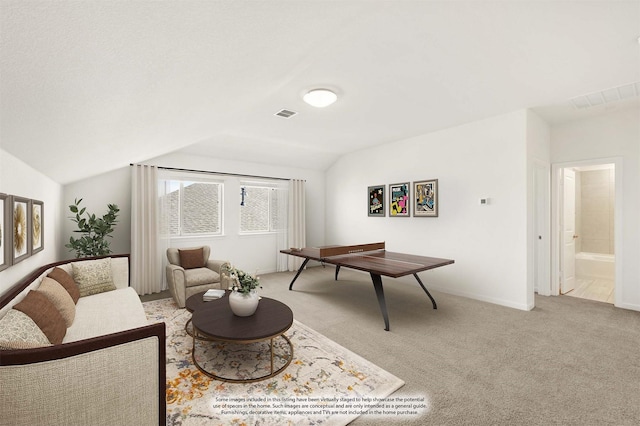 living room featuring light carpet and vaulted ceiling