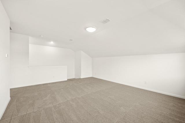 bonus room featuring carpet floors and vaulted ceiling