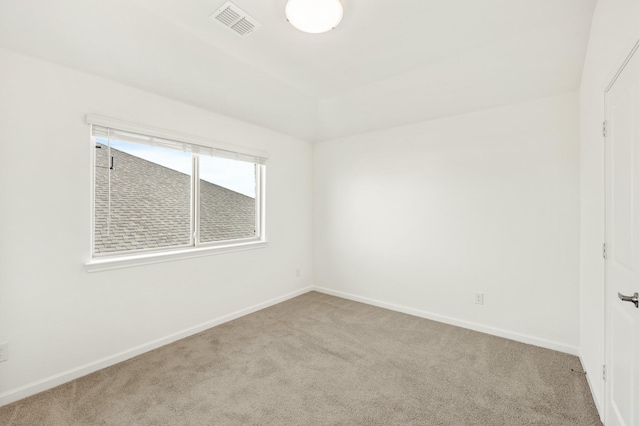 unfurnished room featuring light carpet