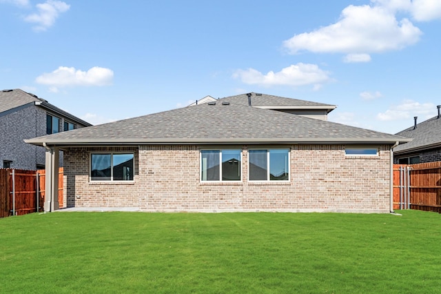 rear view of property featuring a yard