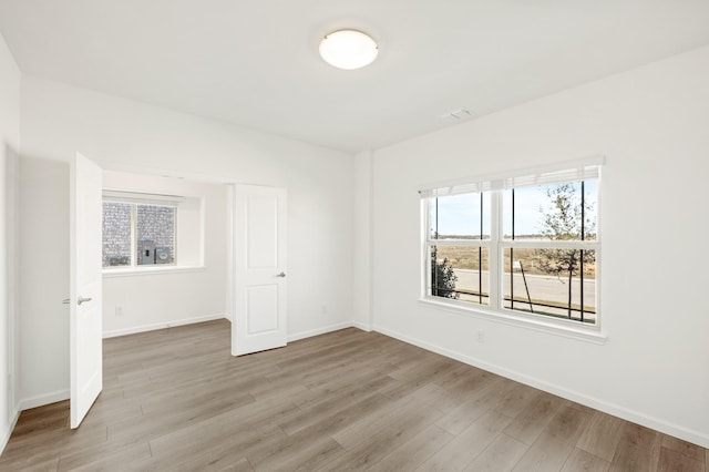 unfurnished room featuring light hardwood / wood-style flooring