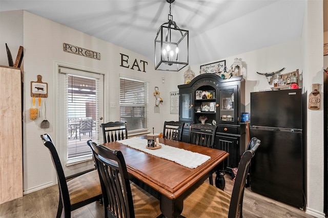 dining space featuring an inviting chandelier and light hardwood / wood-style floors