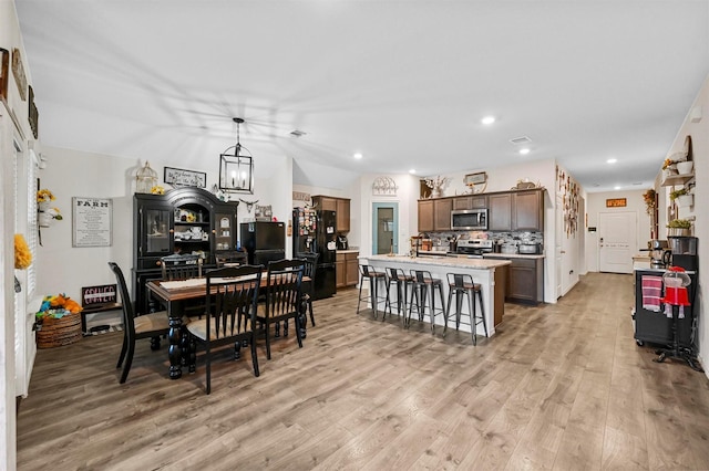 dining space featuring light wood-style floors and recessed lighting