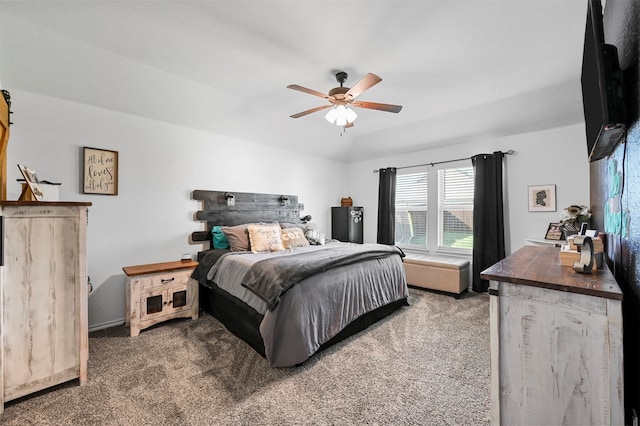 bedroom featuring ceiling fan and dark carpet