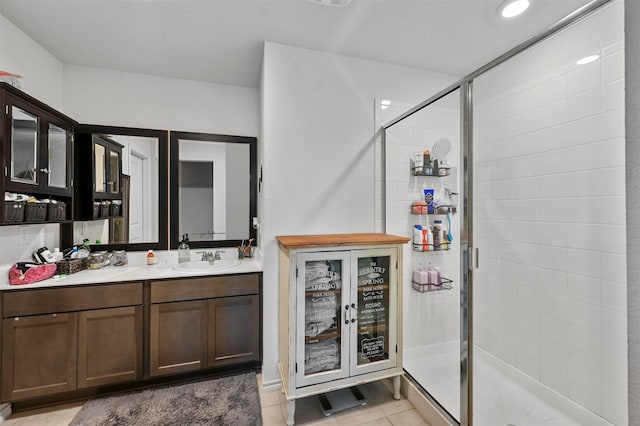 bathroom featuring vanity, tile patterned flooring, and a shower with door