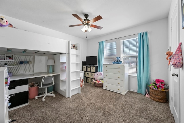 carpeted office with a ceiling fan
