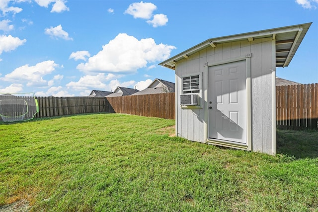 view of shed with a fenced backyard and cooling unit