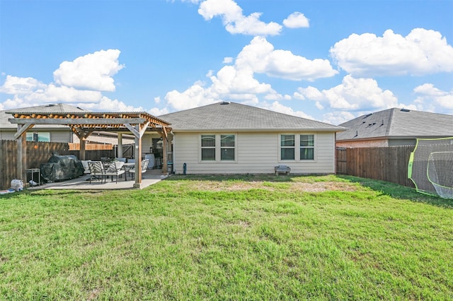 back of house with a lawn, a pergola, and a patio