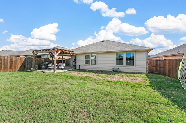 rear view of house with a pergola, a yard, and a patio area