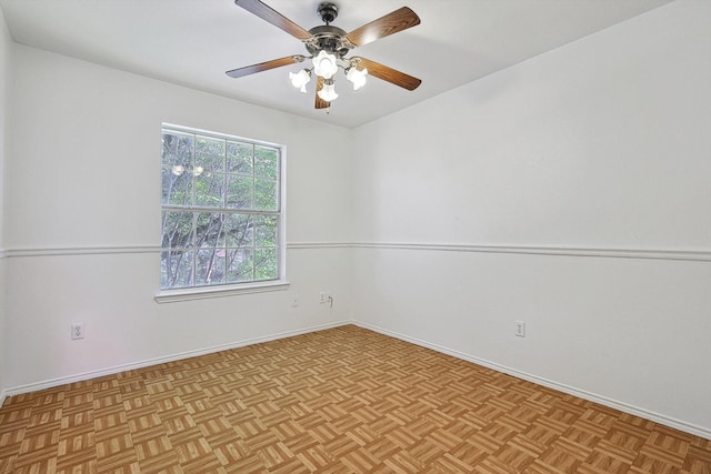 unfurnished room with ceiling fan and light parquet flooring