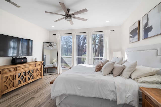 bedroom featuring light wood-type flooring and ceiling fan