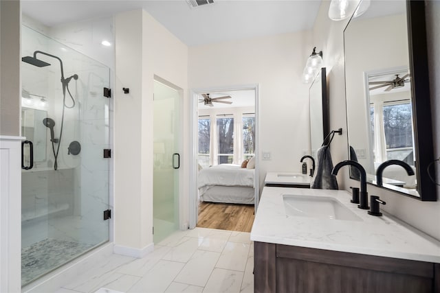 bathroom featuring vanity, ceiling fan, and a wealth of natural light