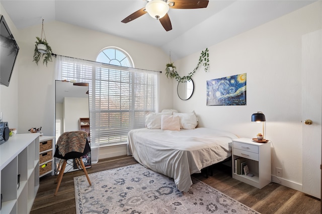 bedroom with vaulted ceiling, ceiling fan, and dark wood-type flooring