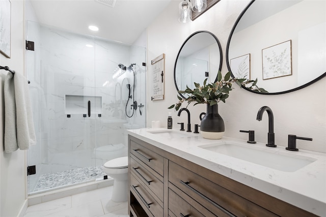 bathroom featuring a shower with door, toilet, and vanity