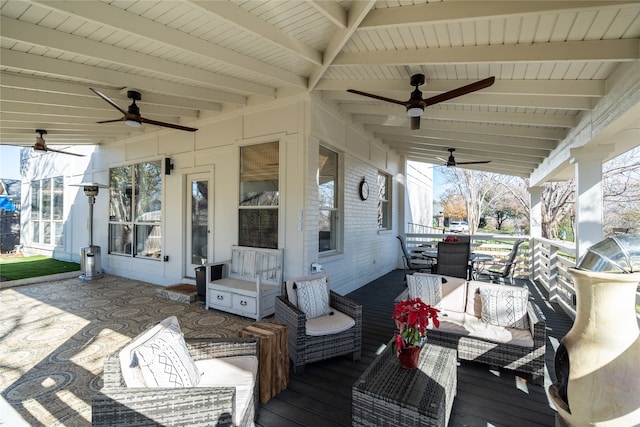 wooden terrace featuring ceiling fan and an outdoor hangout area